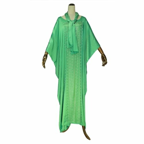 Elegant green kaftan dress with beaded embellishments on a mannequin.