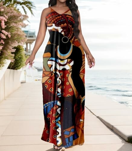 Woman in a colorful patterned dress walking by the seaside.